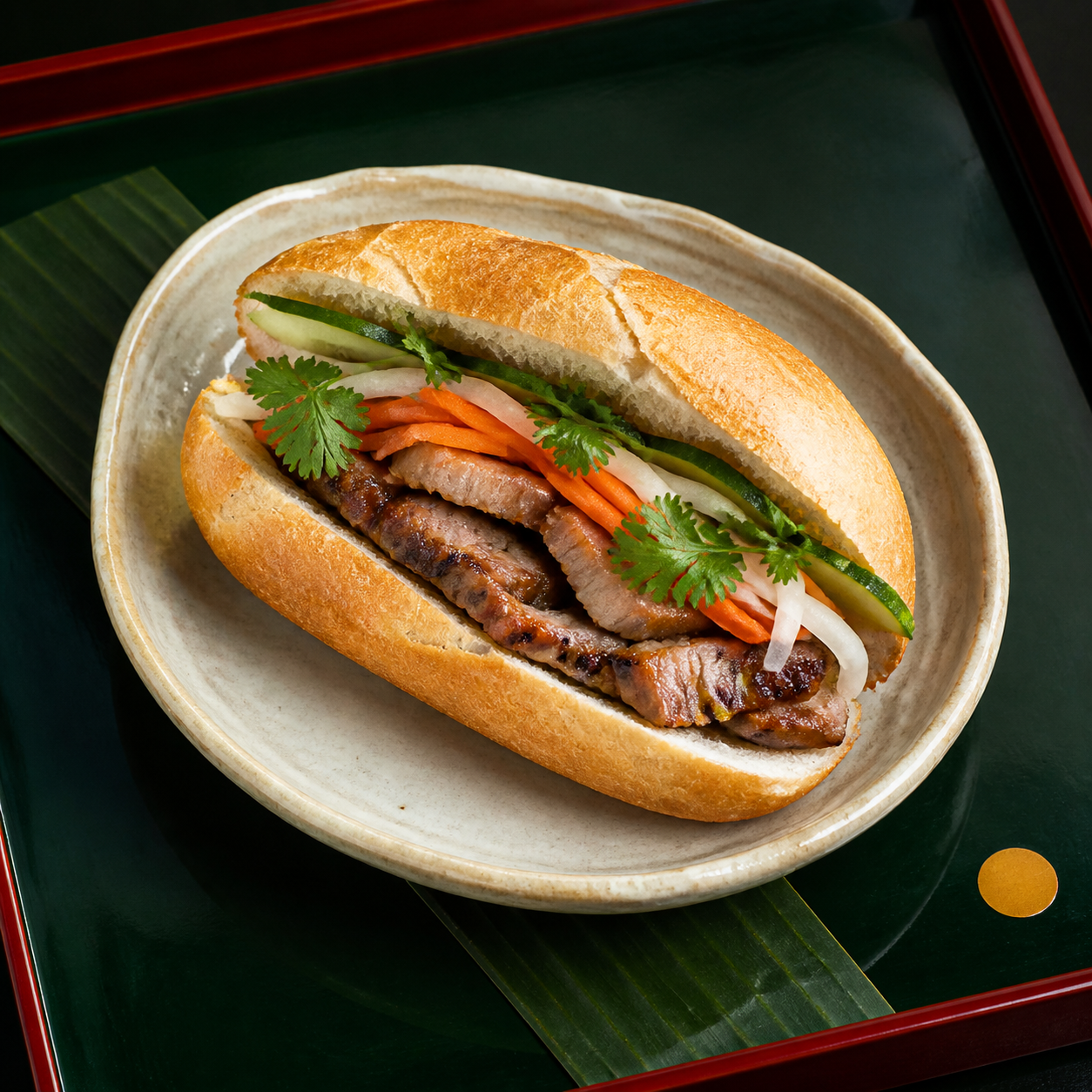 A cut bánh mì thịt nướng sandwich with grilled pork, pickled vegetables, cucumber, and cilantro.